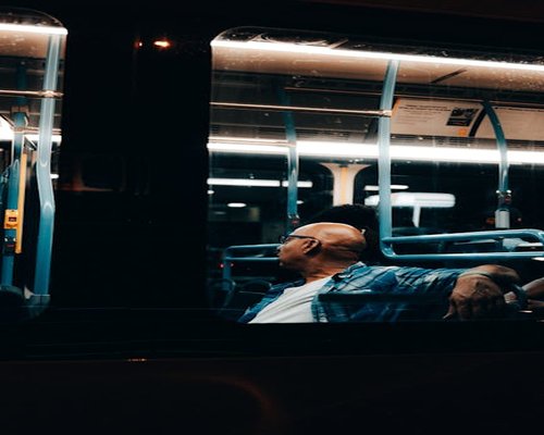 Commuter looking out the window on a busy city bus